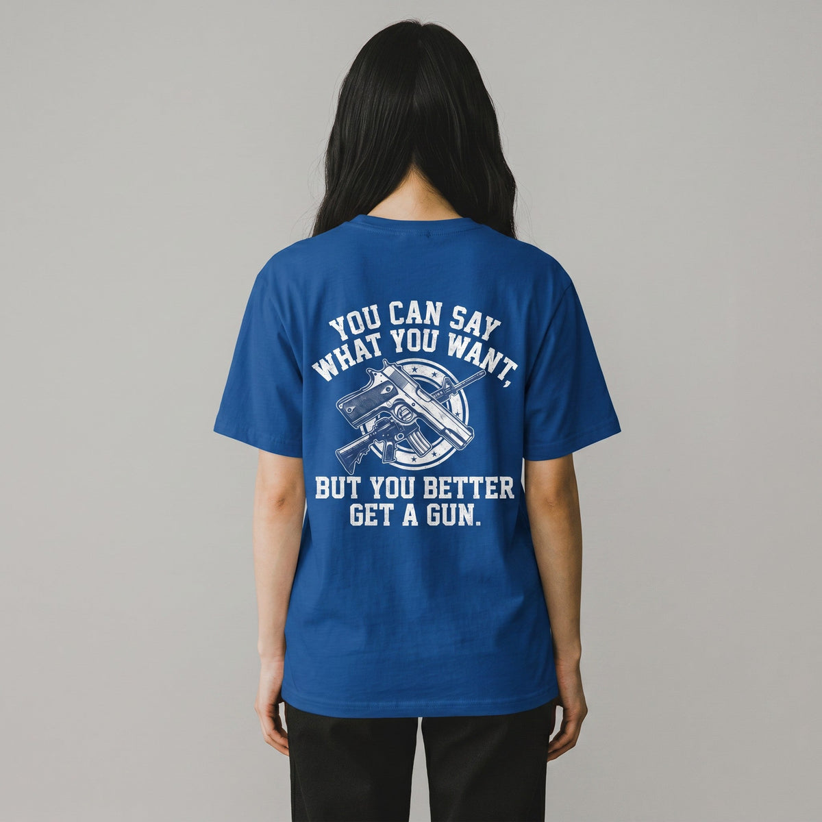  blue cotton t-shirt featuring a white graphic print of a gun and text on the back