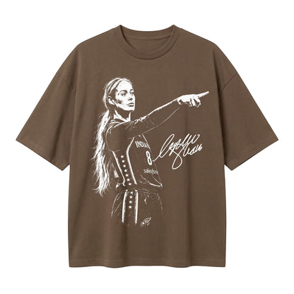  brown oversized t-shirt featuring a white graphic of a female basketball player pointing and a signature