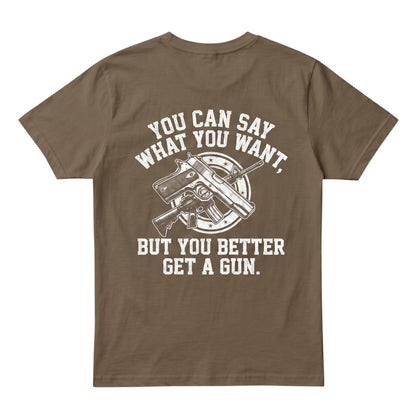  brown cotton t-shirt with a white graphic print of crossed firearms and bold text on the back.