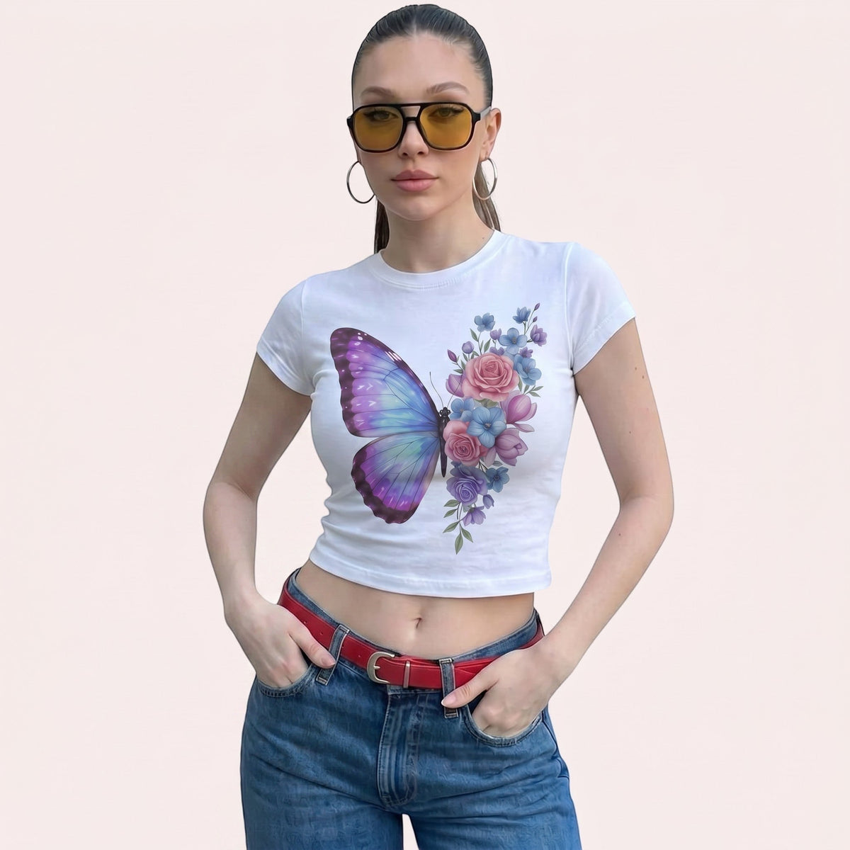  white micro rib baby tee featuring a pastel butterfly and floral print worn by a woman in sunglasses.