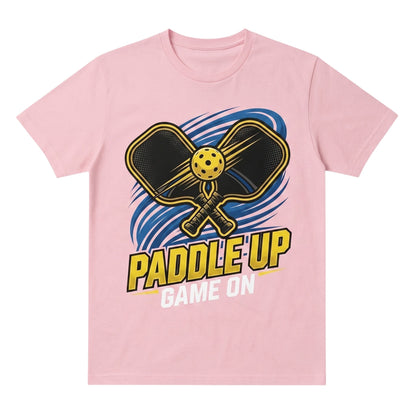  light pink cotton t-shirt featuring a Paddle Up Game On pickleball graphic with paddles and ball.