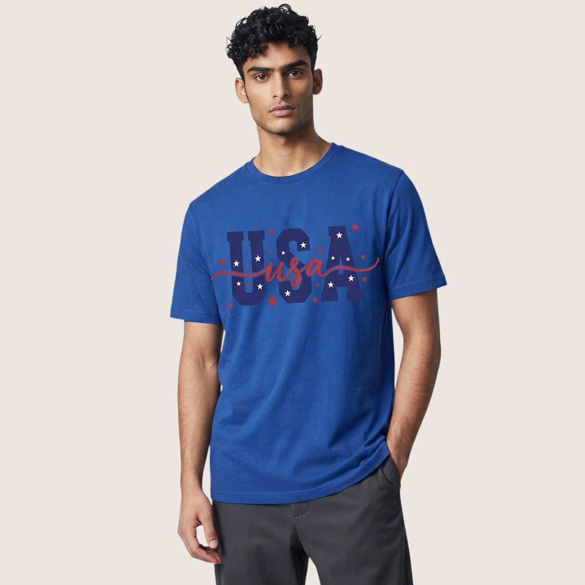  unisex blue cotton t-shirt with USA patriotic star graphic and red script lettering on a male model