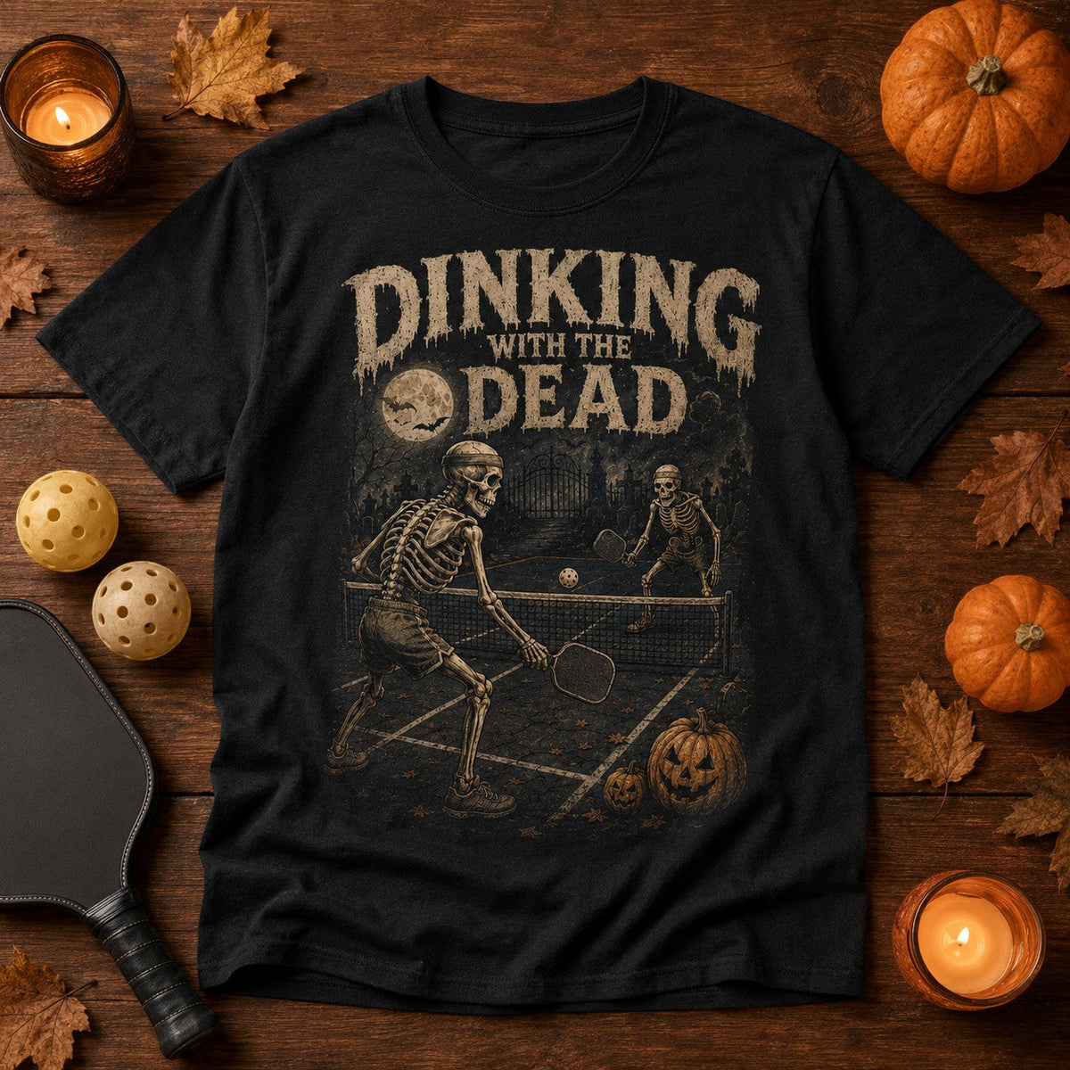 black cotton t-shirt featuring a vintage skeleton pickleball graphic for Halloween.